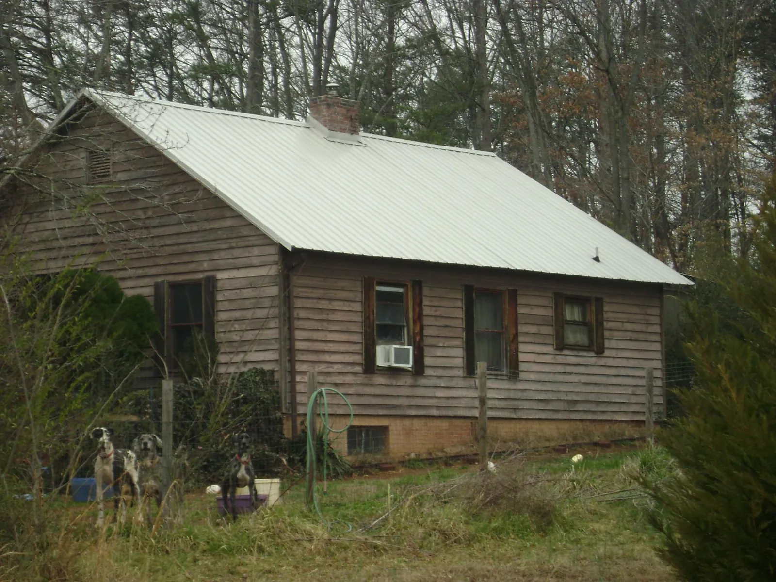 White metal roof on an old wood sided farmhouse, from a Metal Roof Installation job in Heathsville